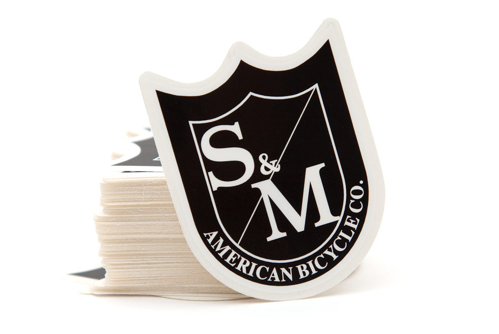 S&M BLACK SHIELD STICKER MEDIUM 6CM X 5CM